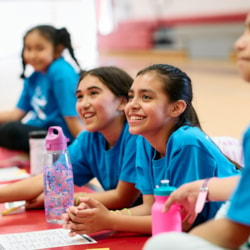 Two GOTR participants smile while listening to their Coach